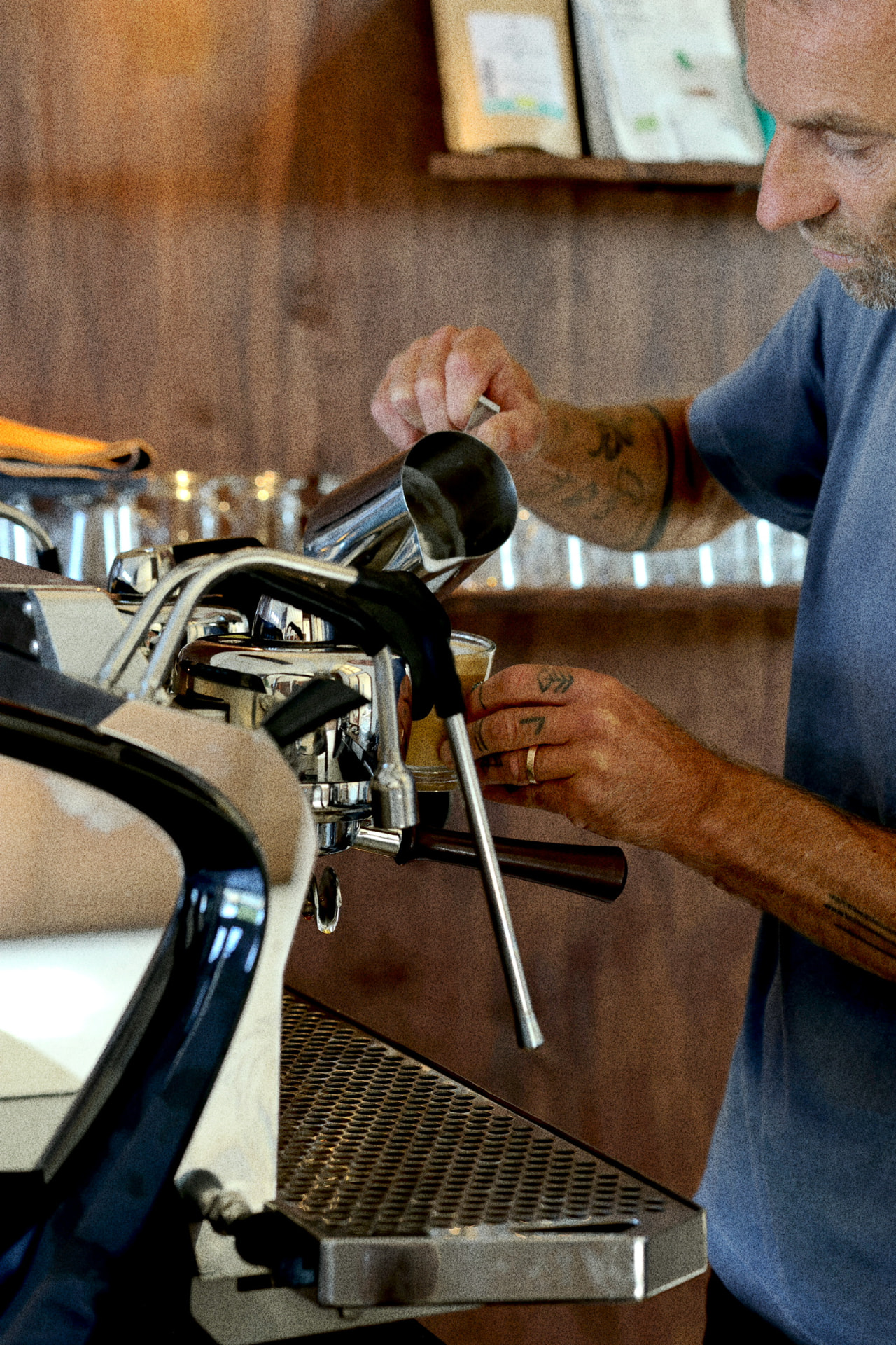 Barista preparing a coffee at the Frank's Market counter